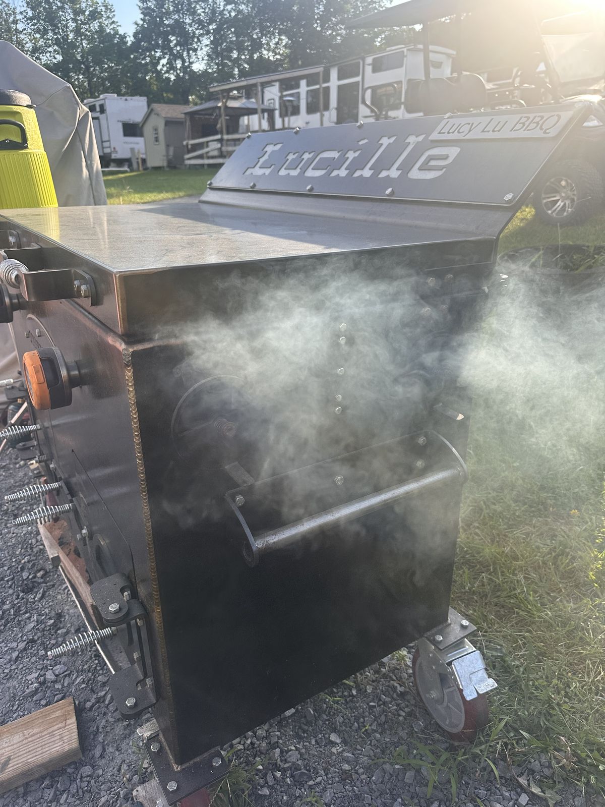 Lucille, the Lucy Lu BBQ Smokeslinger, with smoke rolling from the chamber