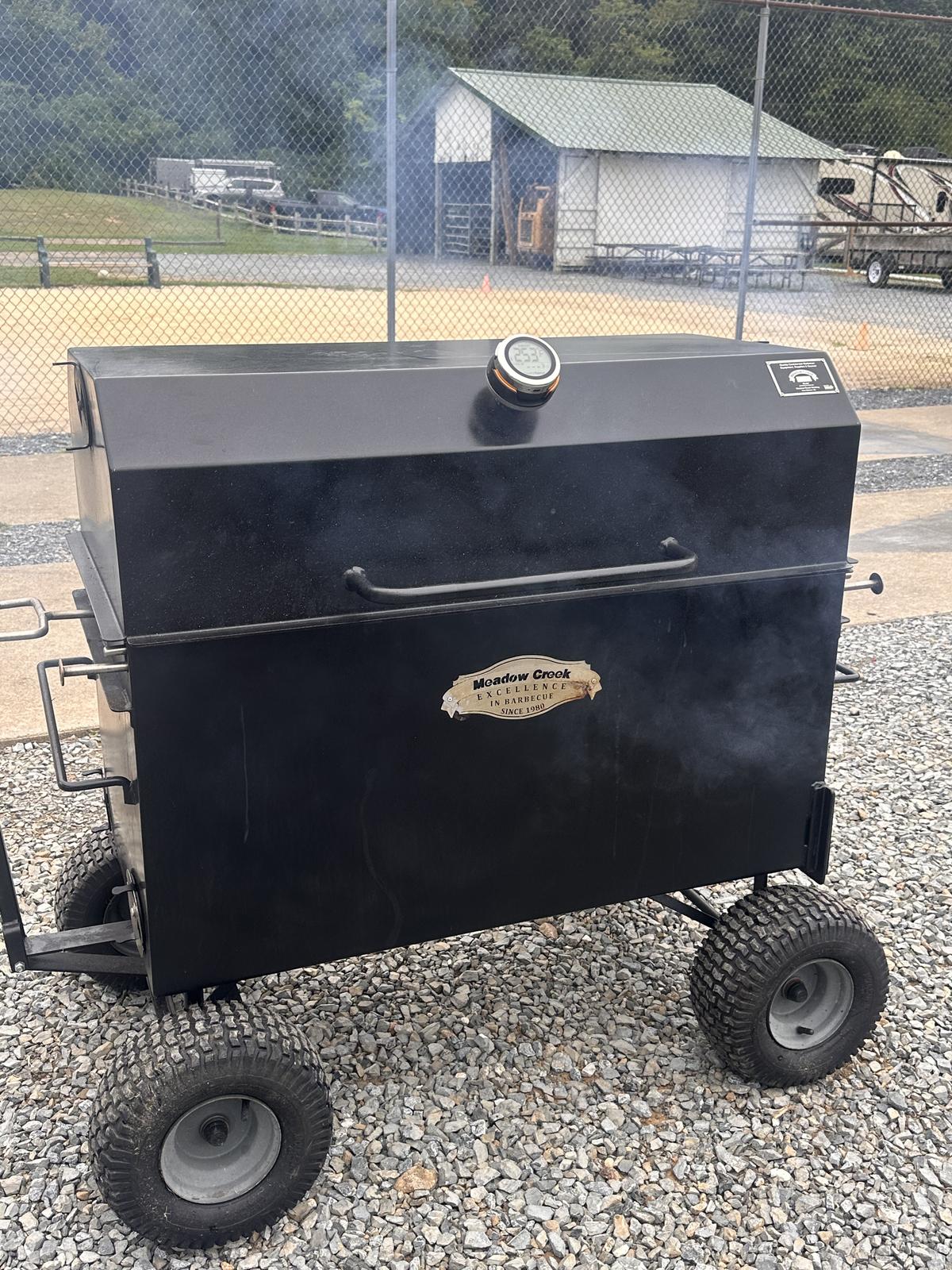Connie, the black Meadow Creek Combi 42 box cooker on large knobby wheels
