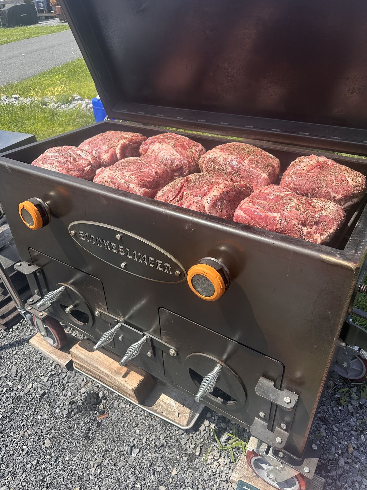 A Smokeslinger smoker loaded edge to edge with seasoned pork butts
